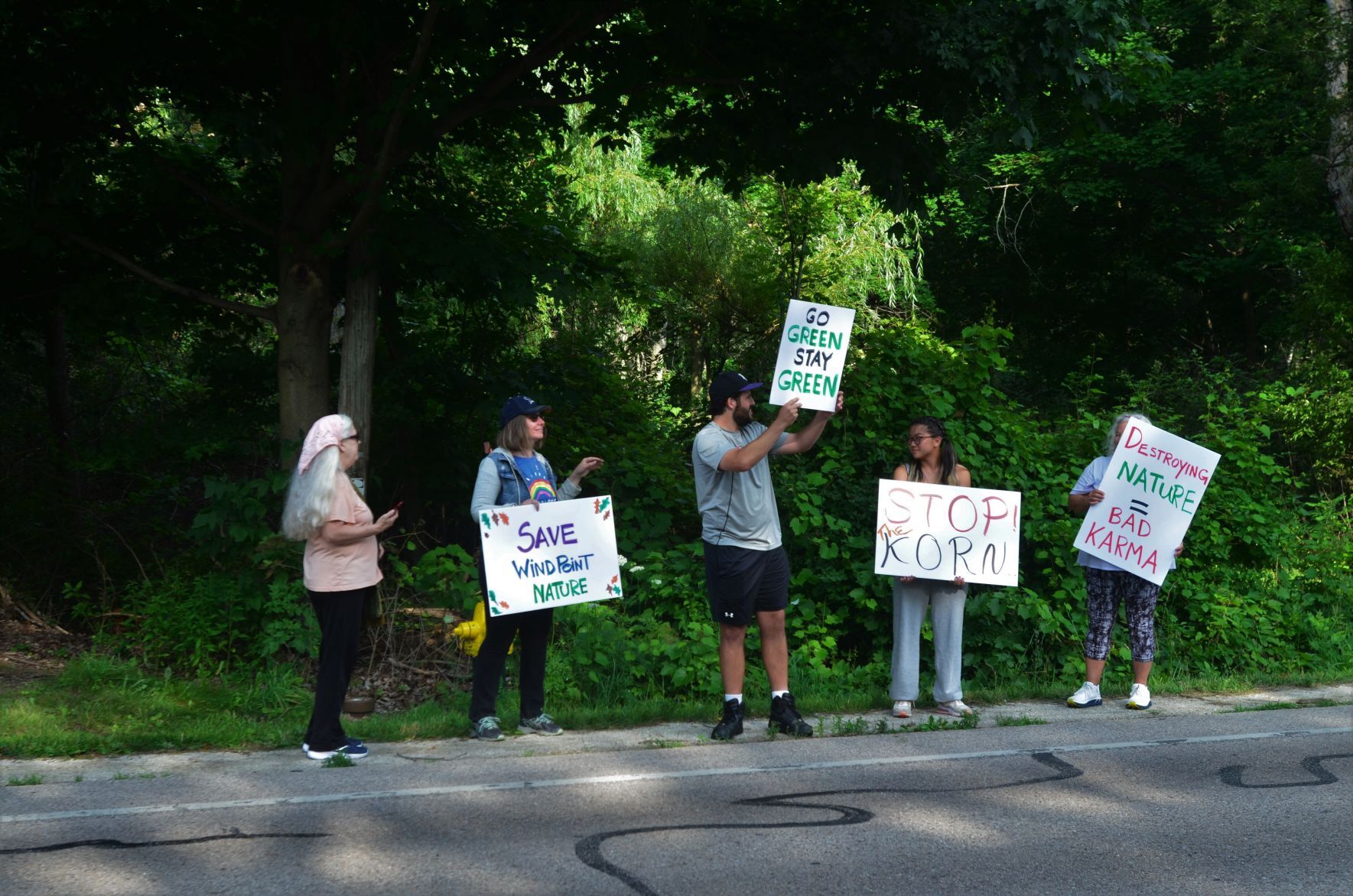 Protestors hold signs